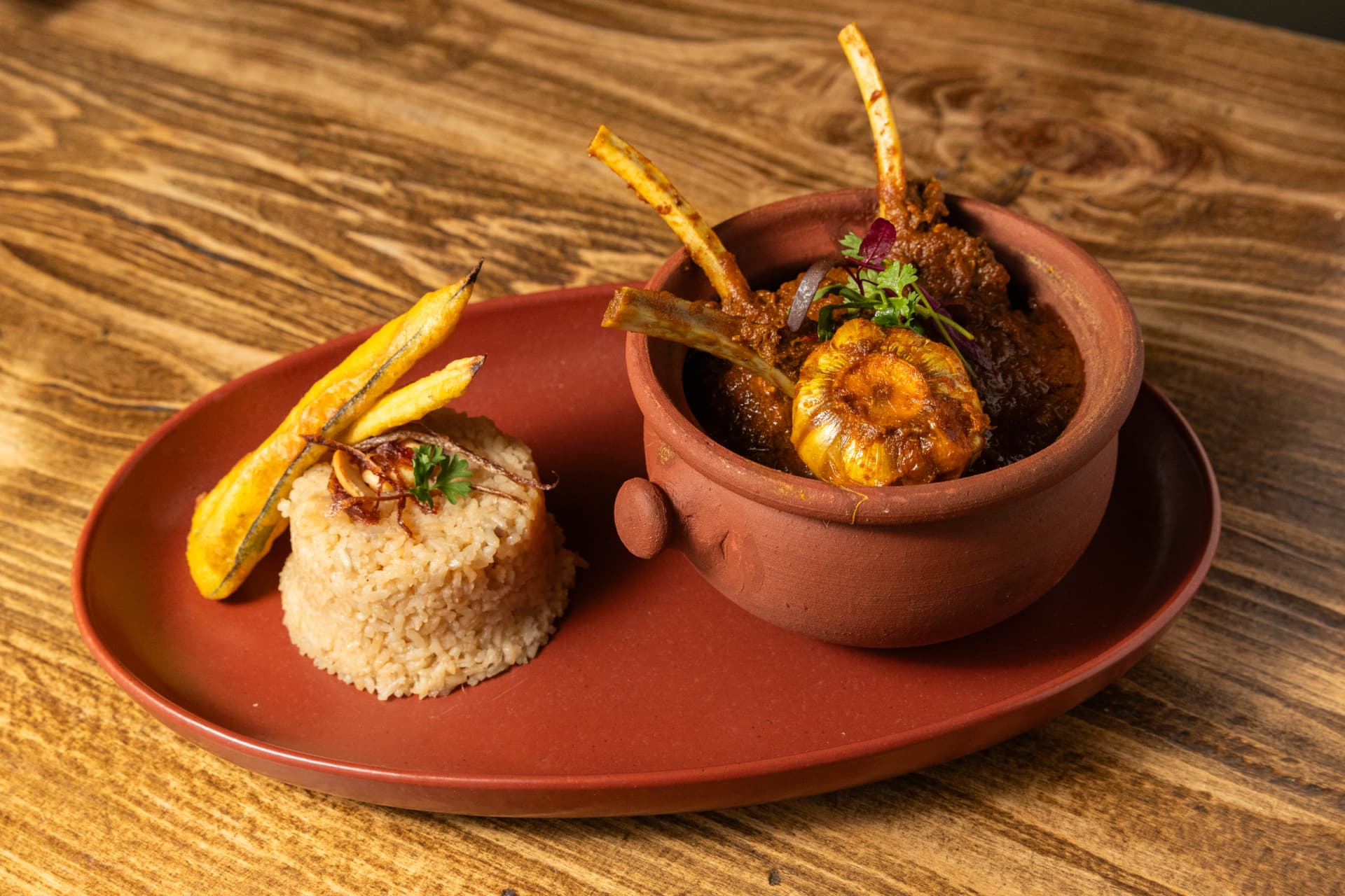 Claypot curry served with fragrant rice and plantain