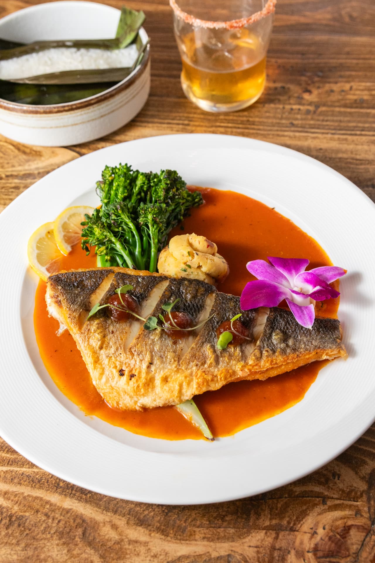 Pan-seared fish in a red curry sauce with broccolini