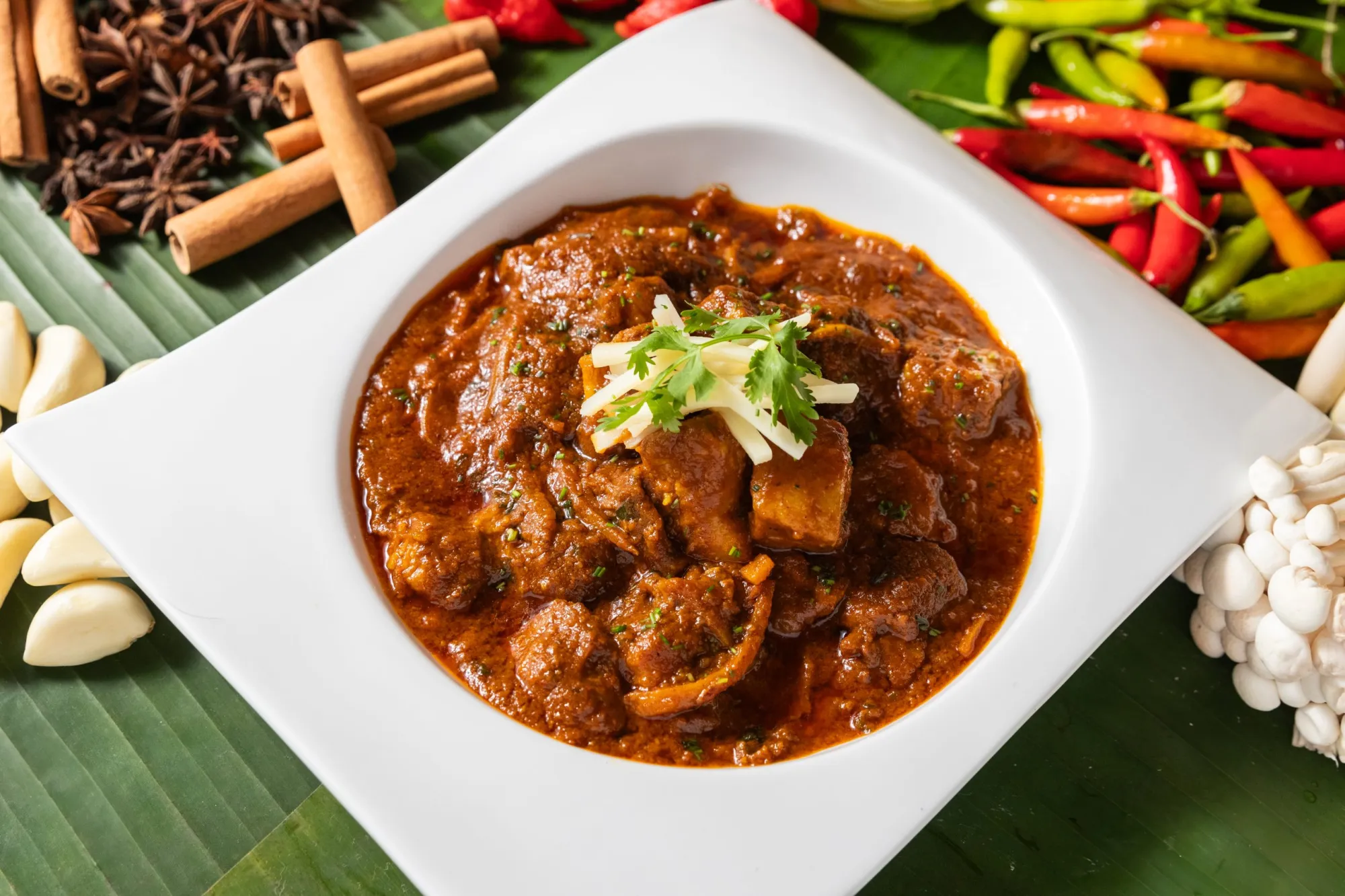 Heritage Pork — braised pork with fermented bamboo shoots in a rich gravy, garnished with ginger and coriander