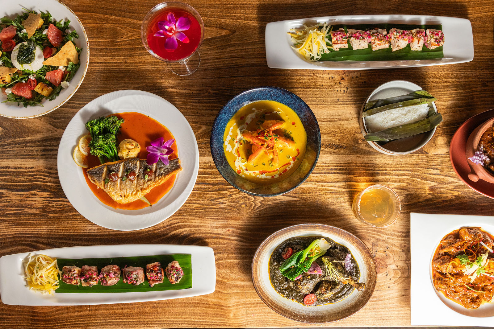 A spread of Northeast Indian dishes on a wooden table