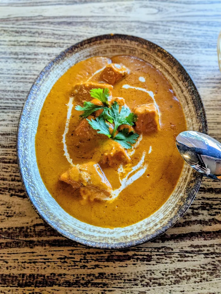 Butter paneer curry with cream swirls and coriander
