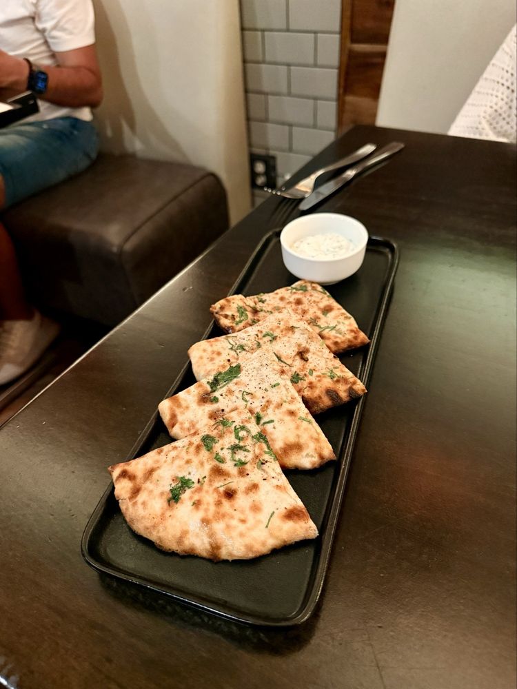 Tandoor Pockets — golden stuffed flatbread wedges with herbs, served with a creamy dipping sauce
